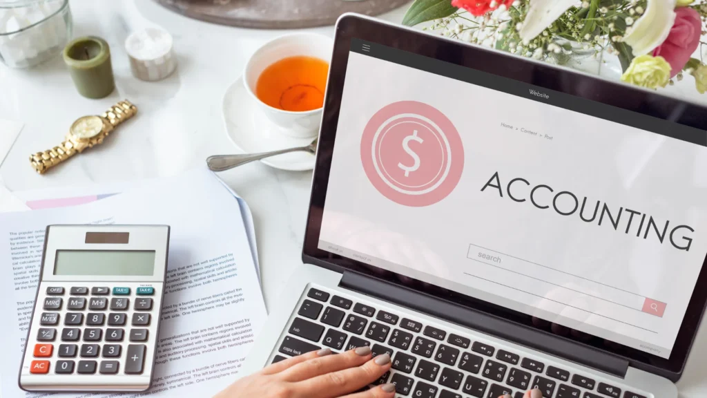 Laptop screen displaying the word accounting with a calculator on the side